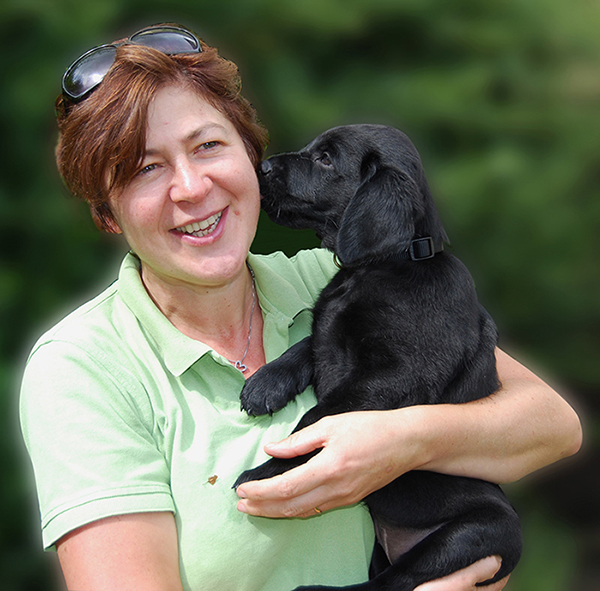 Mairead Whelan from You and Your Dog holding a black labrador puppy in her arms