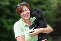 Mairead Whelan from You and Your Dog with black labrador pup. Copyright You And Your Dog
